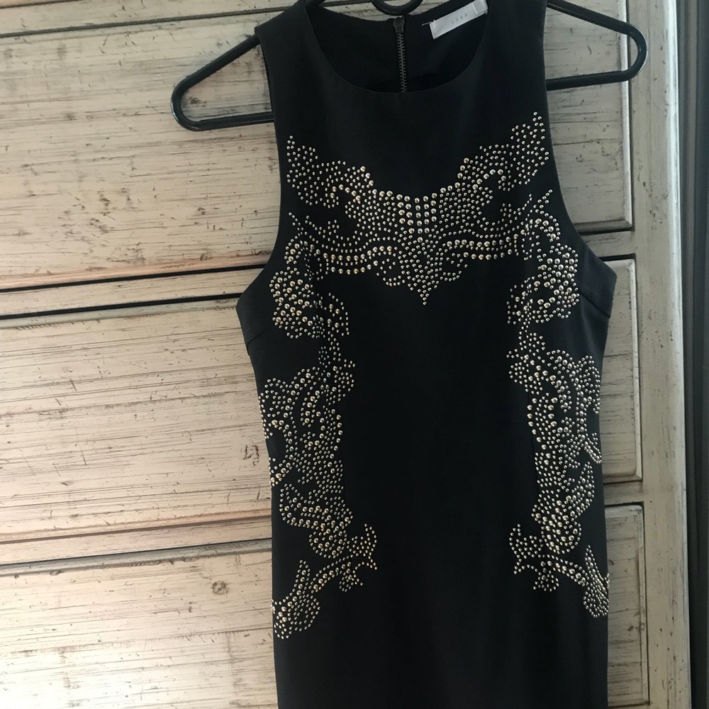 Black body con dress with gold detailing.